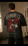 Person wearing a black t-shirt with 'RYNOFLX' design on the back, standing in a room.